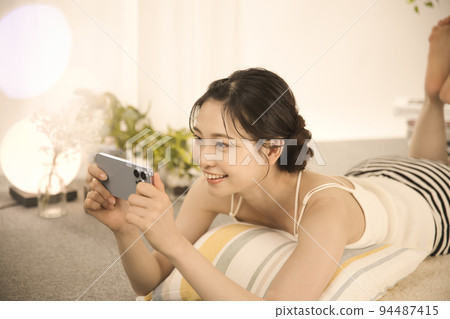A young woman looking at a sleep with lying down 94487415