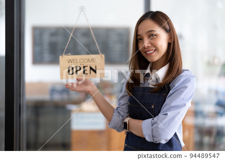 Welcome open shop barista waitress open sign on glass door modern coffee shop ready to serve restaurant cafe retail small business owners. Welcome open shop barista waitress open sign on glass door modern coffee shop ready to serve restaurant cafe retail small business owners. 94489547