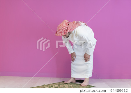 Young muslim man praying salat during Ramadan 94489612
