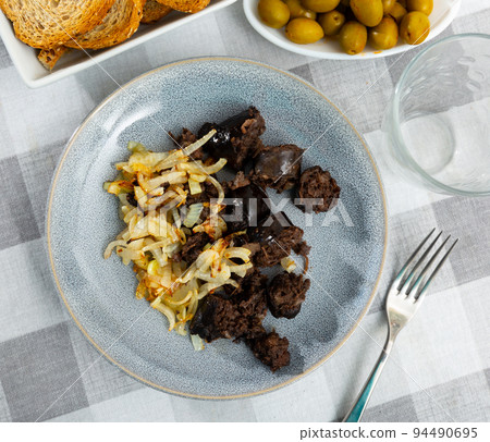 Delicious fried morcilla (blood sausage with rice) and grilled onion served on plate Delicious fried morcilla (blood sausage with rice) and grilled onion served on plate 94490695