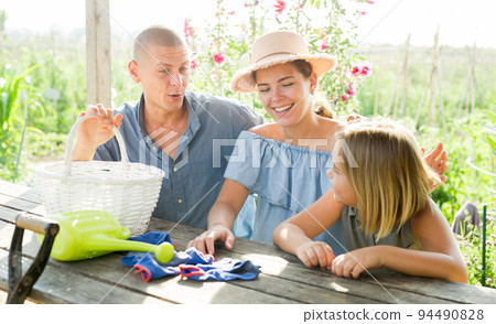 Portrait of happy family at table in courtyard of country house 94490828