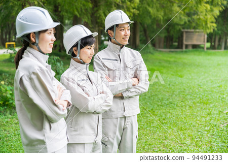 Young men and women in work clothes 94491233