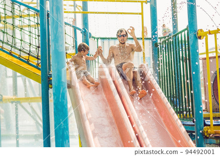 Father and son have fun at the water park Father and son have fun at the water park 94492001