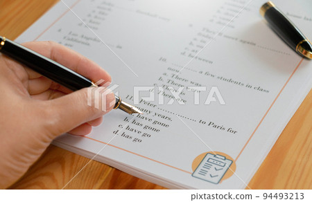 English test with pen on wooden table in class 94493213