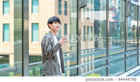 Young businessman operating a smartphone in office casual 94494798