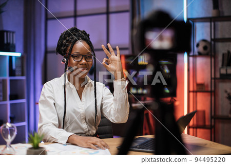 Portrait of confident experienced smart female african american office manager in headset Portrait of confident experienced smart female african american office manager in headset 94495220
