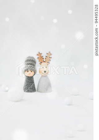 Two people who live in a cold region. An image of a couple and friends snuggling in a snowy landscape. 94495328