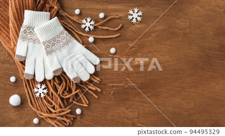 Against the cold in the snowy winter, gloves and scarves background 94495329