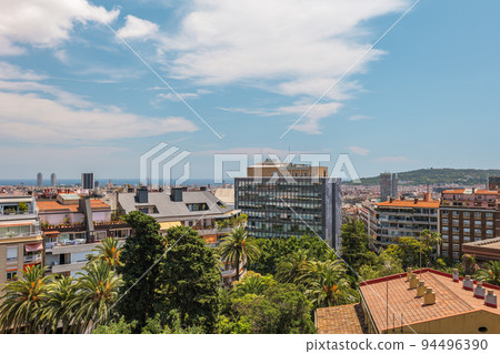 View from a rooftop to the sea and Barcelona city with modern and old buildings. 94496390