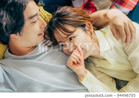A relaxing couple in the living room A relaxing couple in the living room 94496785