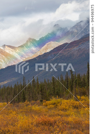 Rainbow in mountains 94496975