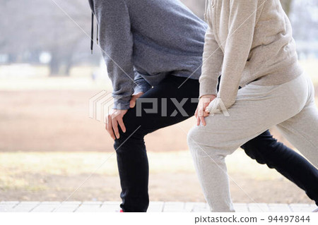 Men and women doing preparatory exercise 94497844