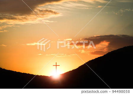 The sunset sky The red sun and clouds and the brightly shining cross of the Holy Church of Jesus Christ 94498038