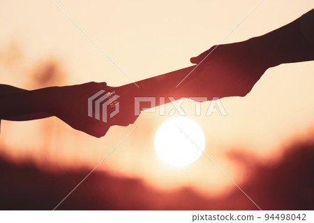 Hands delivering the holy bible and church evangelism concept to spread the gospel of Jesus Christ and love 94498042