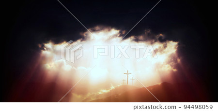 Light and rays of light shining through the sky and clouds on Golgotha Hill Holiness symbolizing the death and resurrection of Jesus 94498059