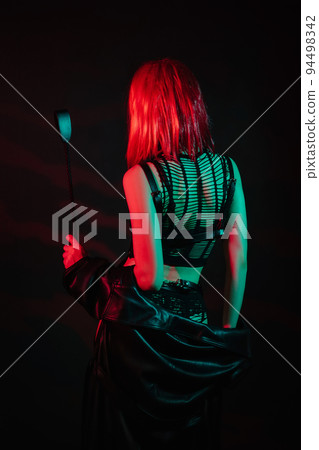 sexy girl with red hair in beautiful underwear stands with her back with a leather whip in her hand for BDSM sex sexy girl with red hair in beautiful underwear stands with her back with a leather whip in her hand for BDSM sex 94498342