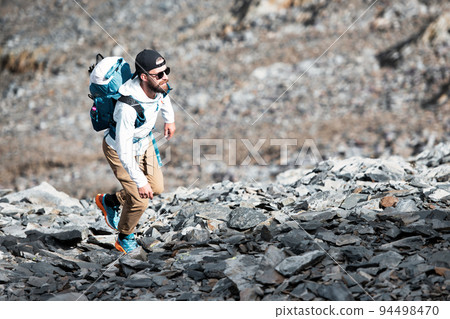 Man during an alpine trek Man during an alpine trek 94498470