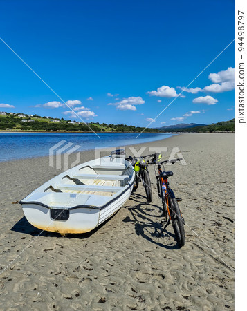 Concept of enjoying the outdoors by bicycle and boat at Gweebarra Bay , County Donegal - Ireland Concept of enjoying the outdoors by bicycle and boat at Gweebarra Bay , County Donegal - Ireland 94498797
