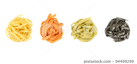 Tagliatelle pasta in different colors, twisted into nests, from above, isolated, over white. Uncooked, dried traditional Italian egg pasta. Long flat ribbons, classic, spinach, tomatoes and squid ink. 94499299