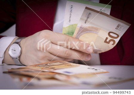 Hand with banknotes. European currency. Business and finance. Economy and banking in Europe. Hand with banknotes. European currency. Business and finance. Economy and banking in Europe. 94499743