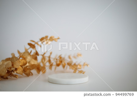 Marble podium with golden leaves on the white background. Podium for product, cosmetic presentation. Creative mock up. Pedestal or platform for beauty products. Marble podium with golden leaves on the white background. Podium for product, cosmetic presentation. Creative mock up. Pedestal or platform for beauty products. 94499769
