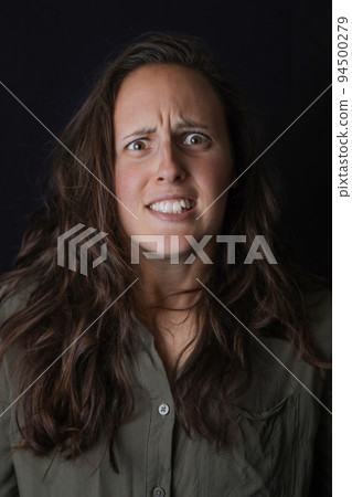 Portrait of impressed girl hear incredible news. Shocked female model on the black background. Expression emotions. Wow, omg, close up. 94500279