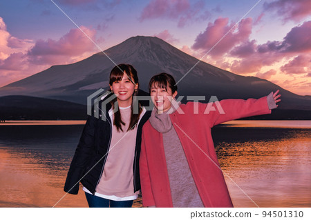 Two women enjoying Mt. Fuji during blue hour at Lake Yamanaka Two women enjoying Mt. Fuji during blue hour at Lake Yamanaka 94501310