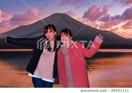 Two women enjoying Mt. Fuji during blue hour at Lake Yamanaka 94501311