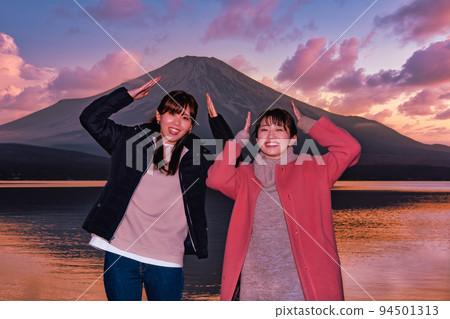Two women enjoying Mt. Fuji during blue hour at Lake Yamanaka Two women enjoying Mt. Fuji during blue hour at Lake Yamanaka 94501313