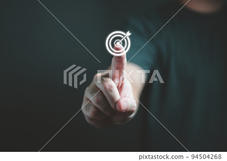 Businessman hand touching target dartboard to setup goal and achievement objectives for business investment. Business financial and startup concept. Businessman hand touching target dartboard to setup goal and achievement objectives for business investment. Business financial and startup concept. 94504268