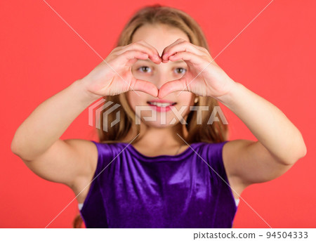Symbol of love. Kid adorable girl with long hair smiling face show heart gesture to you. Celebrate valentines day. Love and sympathy. Love concept. Girl cute child show heart shaped hand gesture 94504333