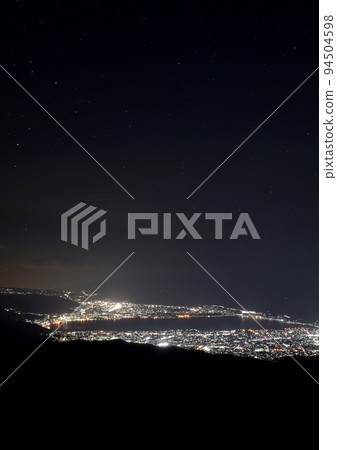 In the hazy night sky, Lake Suwa emerges in neon lights and the constellation Scorpio begins to rise in the Takabocchi Highlands Background photo Dark A column vertical In the hazy night sky, Lake Suwa emerges in neon lights and the constellation Scorpio begins to rise in the Takabocchi Highlands Background photo Dark A column vertical 94504598