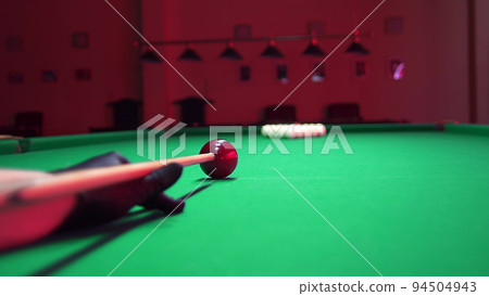 Man Playing Russian Billiards. First Blow Hit Breaking the Ball Pyramid. 4K colorcorrected footage 94504943