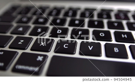 Close-up macro panoramic view of keyboard on the laptop computer. Slow macro soft focus dolly shot. Close-up macro panoramic view of keyboard on the laptop computer. Slow macro soft focus dolly shot. 94504945