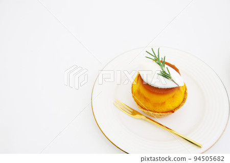 Pumpkin pudding tartlet on a white plate Pumpkin pudding tartlet on a white plate 94505682