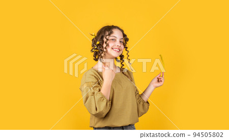 cute kid standing with happy face. Child fashion model concept. childhood happines. Child making hairstyle. little happy girl with curlers in hair. cute little beauty. Best party 94505802