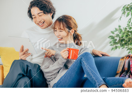 Young men and women looking at a tablet Young men and women looking at a tablet 94506883