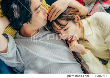 A relaxing couple in the living room A relaxing couple in the living room 94506913