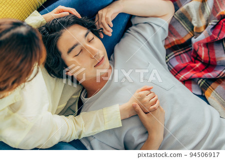 couple lying in the living room 94506917