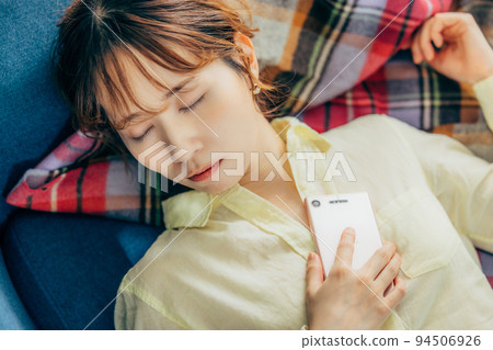 Woman taking a nap on the couch Woman taking a nap on the couch 94506926