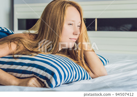 Young beautiful woman woke up in bed close-up 94507412