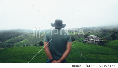 Green rice terraces and huts in the rainy season 94507478