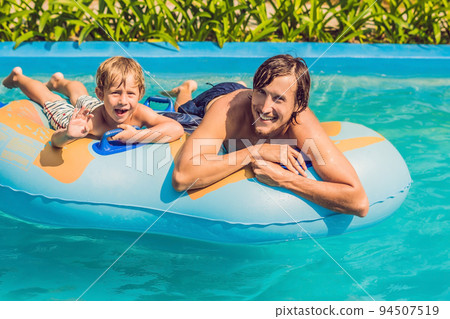 Father and son have fun at the water park Father and son have fun at the water park 94507519
