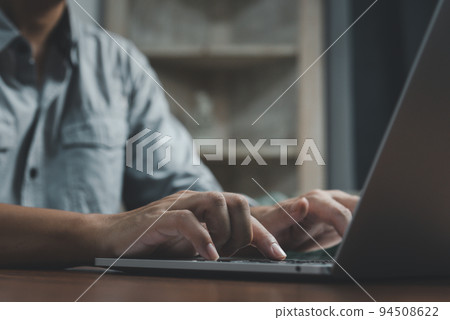 Businessman hand work on keyboard laptop computer at office table close up.business and technology concept. Businessman hand work on keyboard laptop computer at office table close up.business and technology concept. 94508622