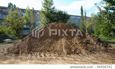 A large mountain of sand in the center of the city brought to repair the road A large mountain of sand in the center of the city brought to repair the road 94508741