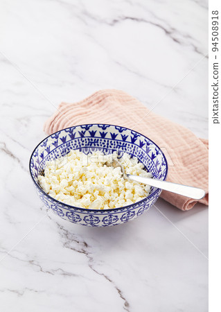 Cottage cheese in bowl on white background 94508918