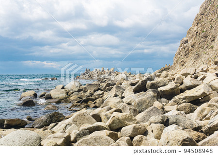sharp jagged basalt rocks on the sea coast sharp jagged basalt rocks on the sea coast 94508948