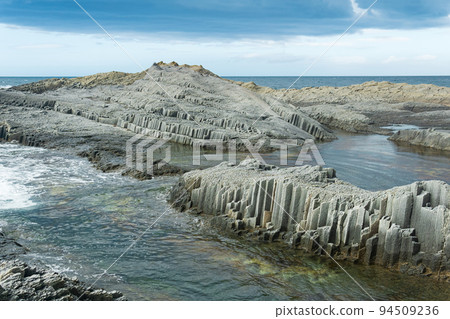 coastal seascape with beautiful columnar basalt rocks at low tide coastal seascape with beautiful columnar basalt rocks at low tide 94509236