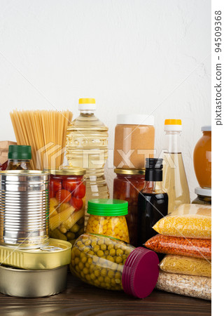 Emergency survival food set on dark wooden kitchen table Emergency survival food set on dark wooden kitchen table 94509368