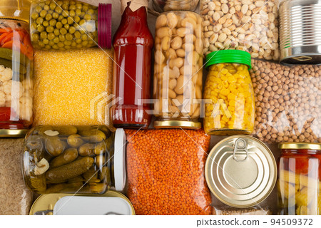 Emergency survival groceries on kitchen table closeup flat lay 94509372